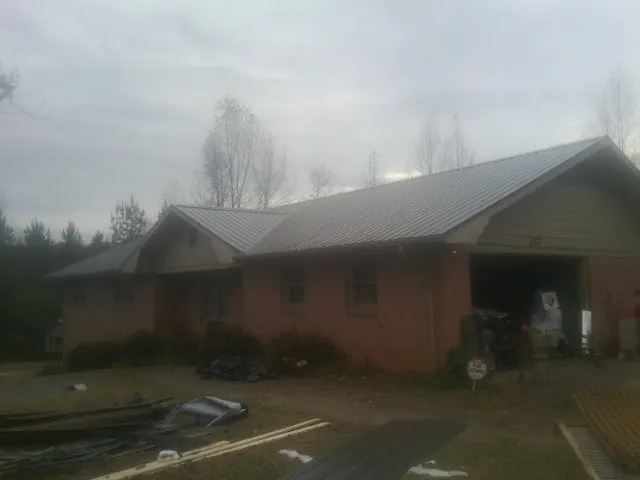 Gray metal roof on a stucco house with an attached garage in Chicago Heights