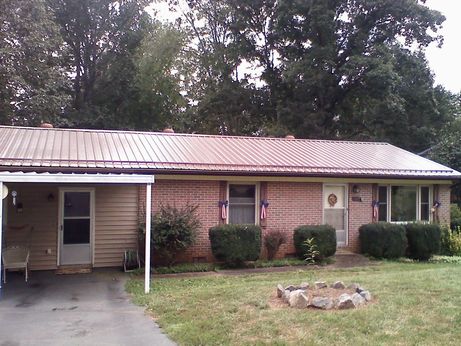 Bronze metal roof and carport on a brick ranch home — Roof Repair work by our crew in Chicago Heights